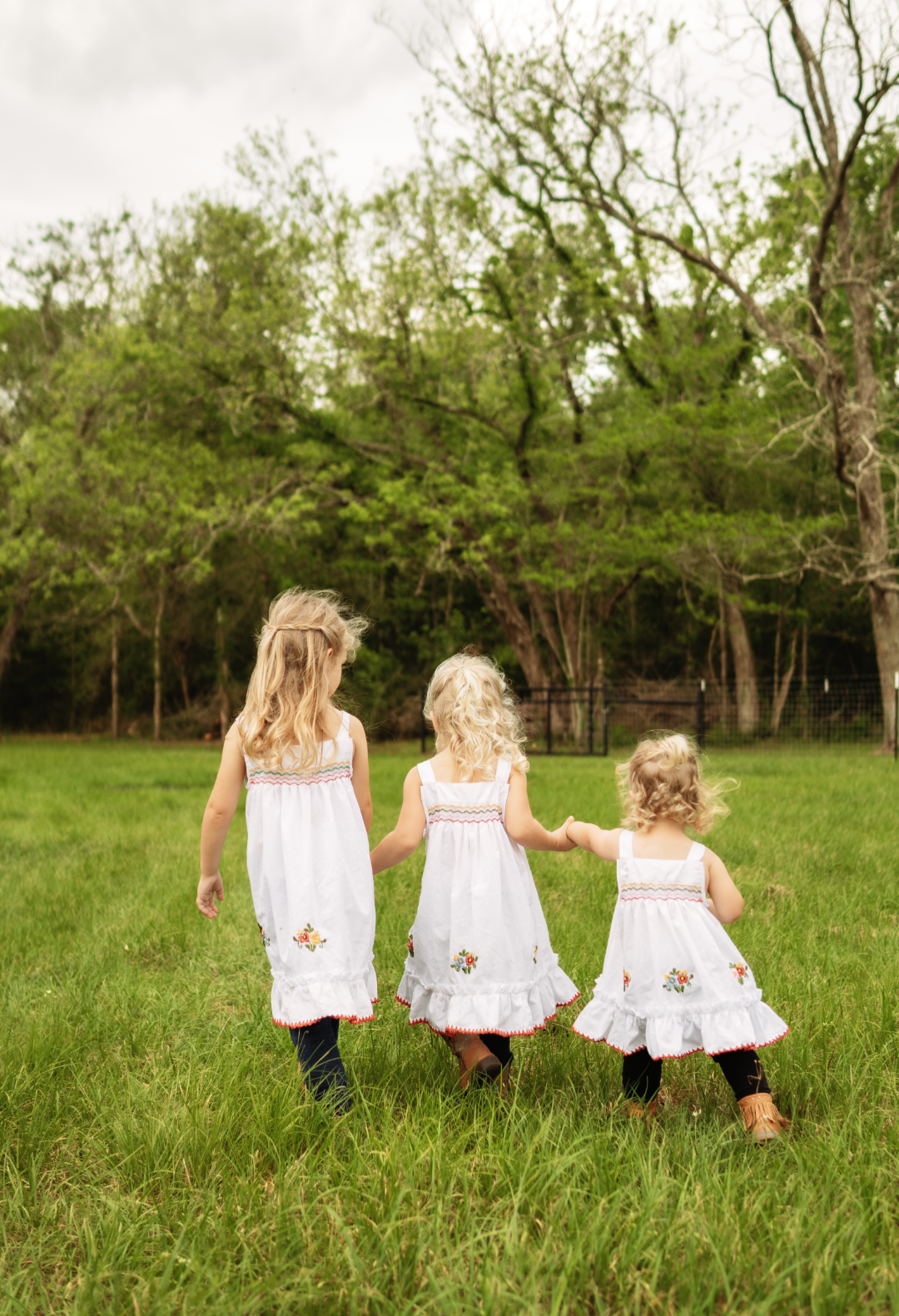 Three children walking through the pasture at Sandy Patch Ranch by Olivia Hurtado